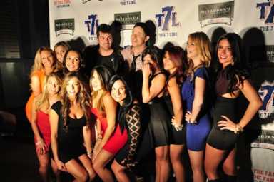 Darren Meenan, founder of The 7 Line, with the 2014 calendar girls.