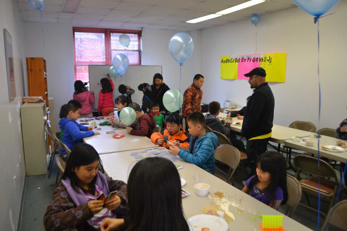 Children played in a recreation room at the YMCA while their parents signed them up for the Fresh Air Fund during a registration kickoff.