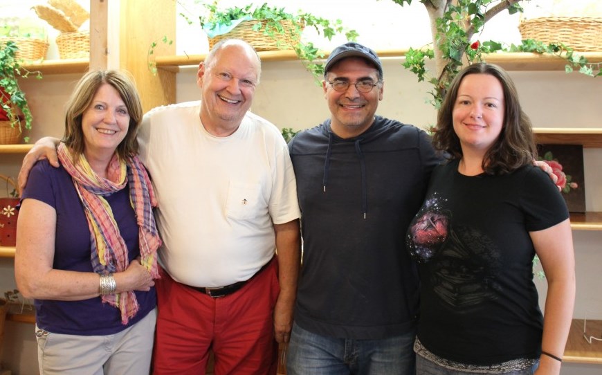 Pia and Peter Aigner (l) pose with their daughter and new owner Mark Libertini inside Aigner's Chocolate shop, soon to be re-opened on Oct. 22.