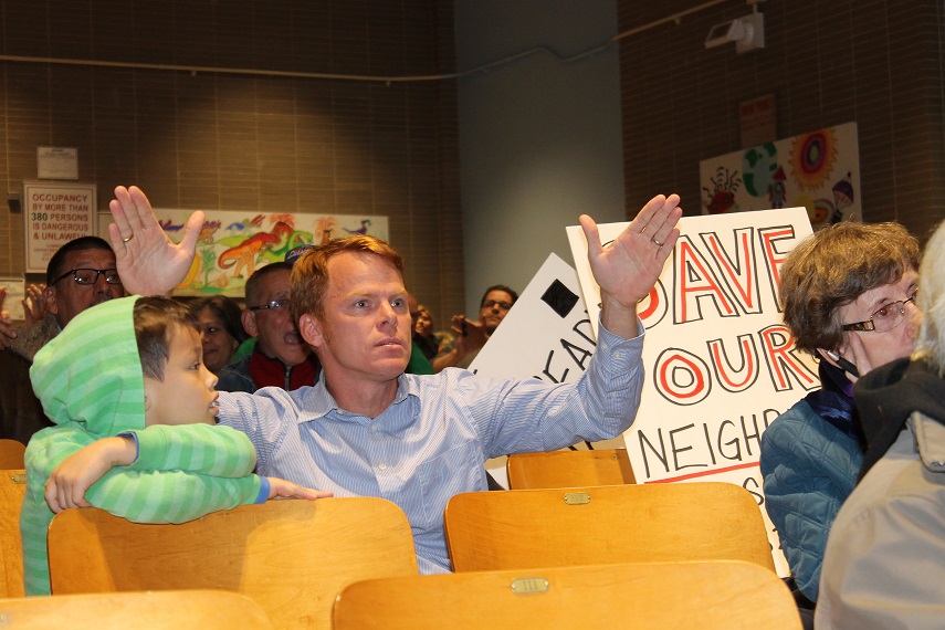 Chadney Spencer speaks up at a meeting on a proposed high school set to be installed at the Bayside Jewish Center.