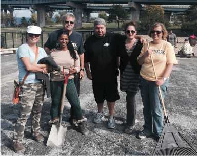 Volunteers worked together to improve the Little Bay Dog Run with new gravel earlier this month.