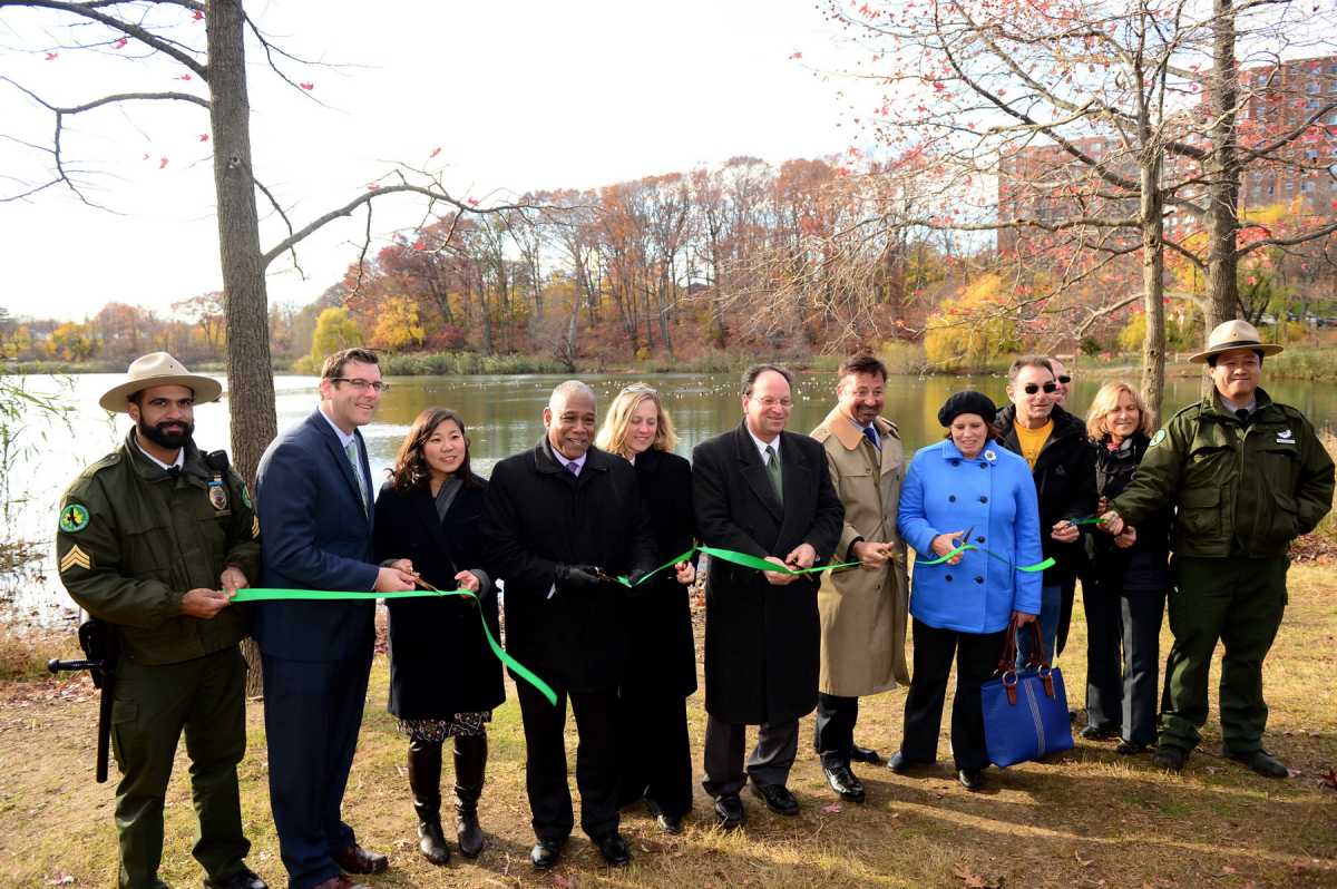 Officials cut a ceremonial ribbon on a re-opened Oakland Lake.