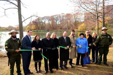Officials cut a ceremonial ribbon on a re-opened Oakland Lake.