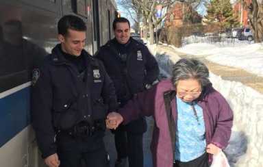 Officers Faulkner (left) and Timpano hold the woman steady.
