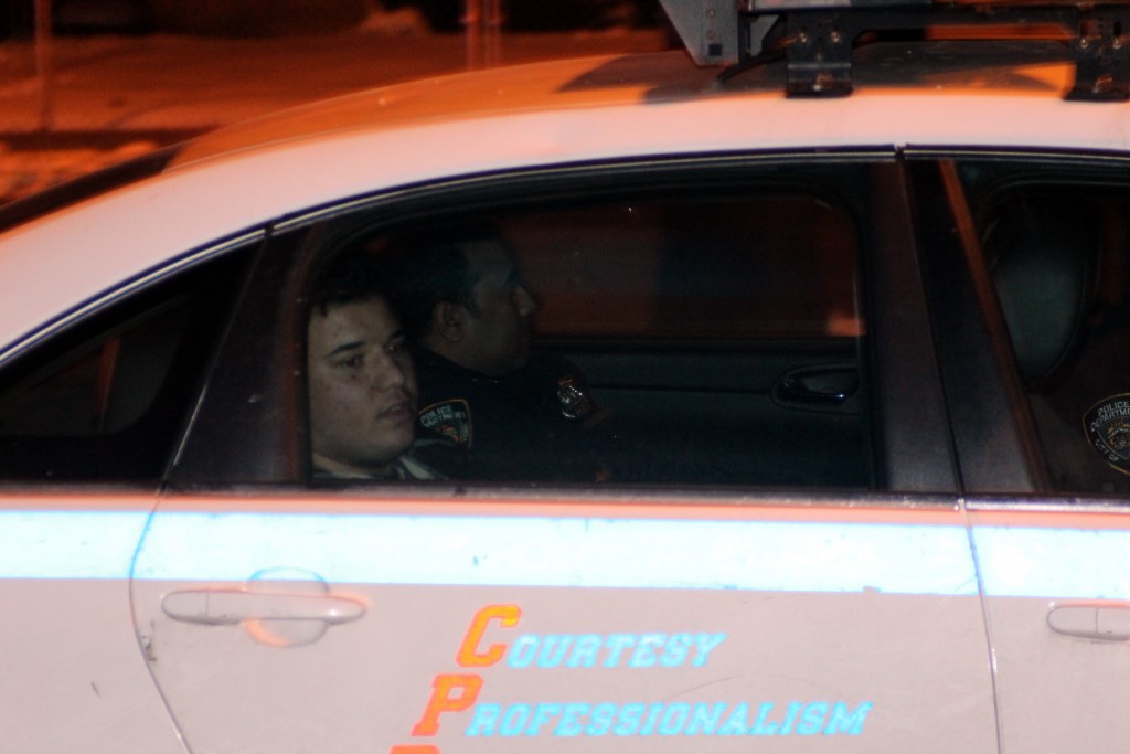 Suspect in custody at the scene as Crime scene investigators at the scene of a 60 year old male beaten to death in front of 47-05 Utopia Parkway in Queens , the car club was used to beat the man to death. The man was rushed to New York hospital of Queens. Photos by Robert Stridiron. 02/06/16