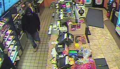 Security camera footage shows a knife-wielding robber in Flushing on May 23.