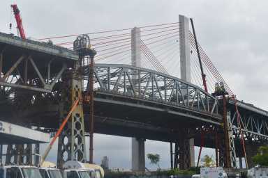 After the main span of the old Kosciuszko Bridge was lowered and barged away in July, crews will implode the bridge approaches on Sept. 24.