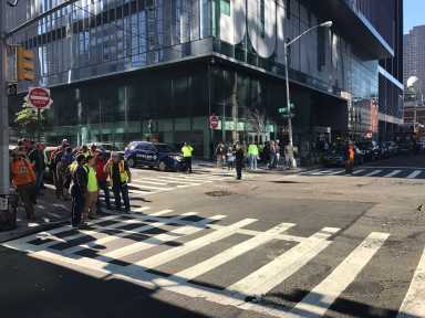 Workers wait outside a construction site in Manhattan after a Queens man shot a foreman there on Oct. 5.