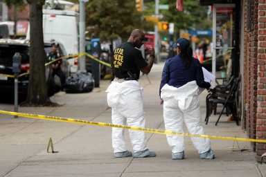Crime scene investigators outside the Ozone Park business where Hani Kassem was murdered on Oct. 23, 2017.