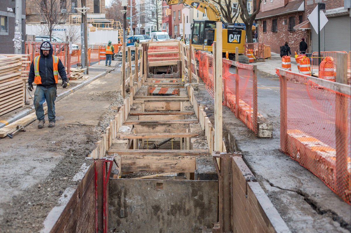 Construction crews digging a sewer trench in Williamsburg.