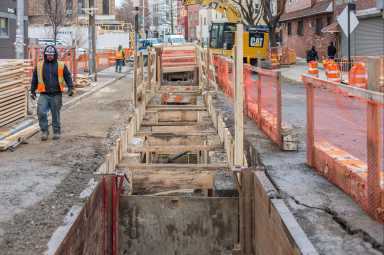 Construction crews digging a sewer trench in Williamsburg.