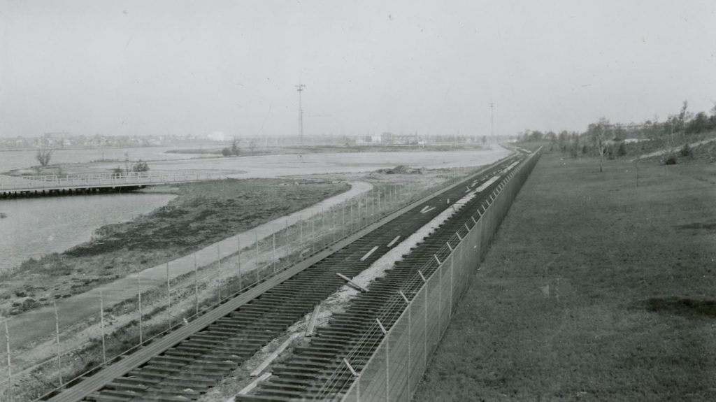 The World's Fair Railroad looking northbound; look carefully in the background and you'll see the Trylon and Perisphere, the two symbols of the 1939-40 World's Fair in the distance (photo via Queens Library Digital Archives)