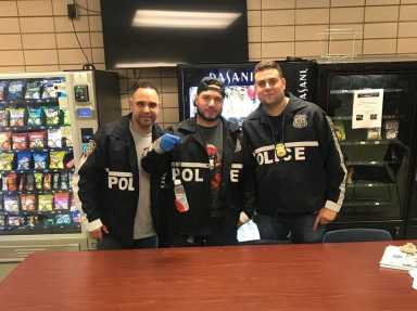 Members of the 112th Precinct holding an improvised mailbox fishing device seized during a May 4 arrest.