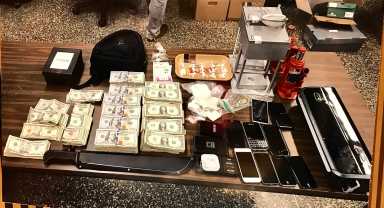 Some of the proceeds of police raids in Queens on May 23 connected to a lengthy drug and gun sale investigation.