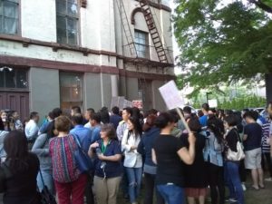 Attendees rally outside of Poppenhusen Institute