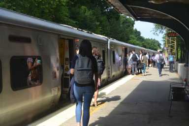 Passengers boarding a westbound train at the Long Island Rail Road Bayside station.
