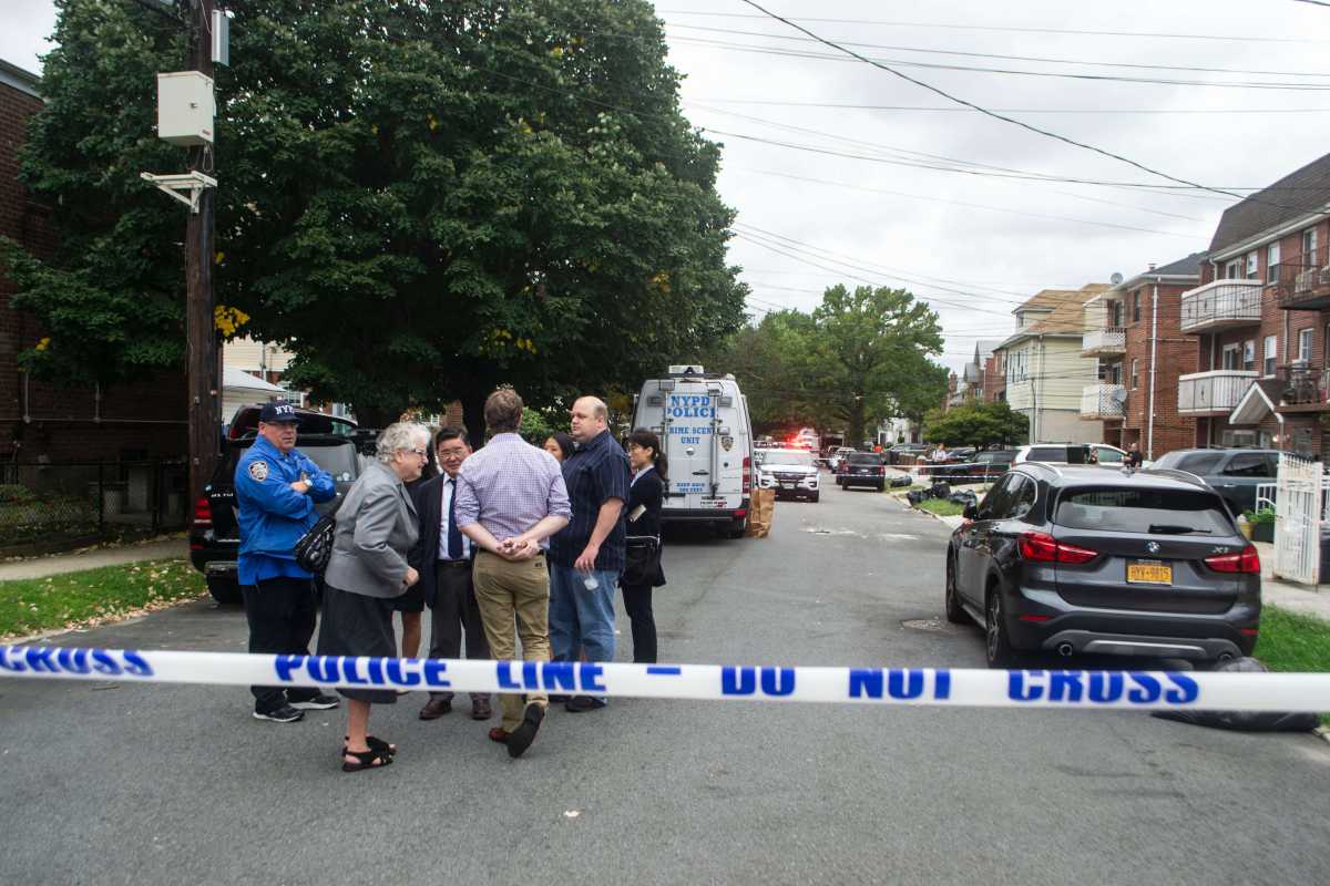 Police and local officials outside the 161st Street day care center where five people were stabbed on Sept. 21.