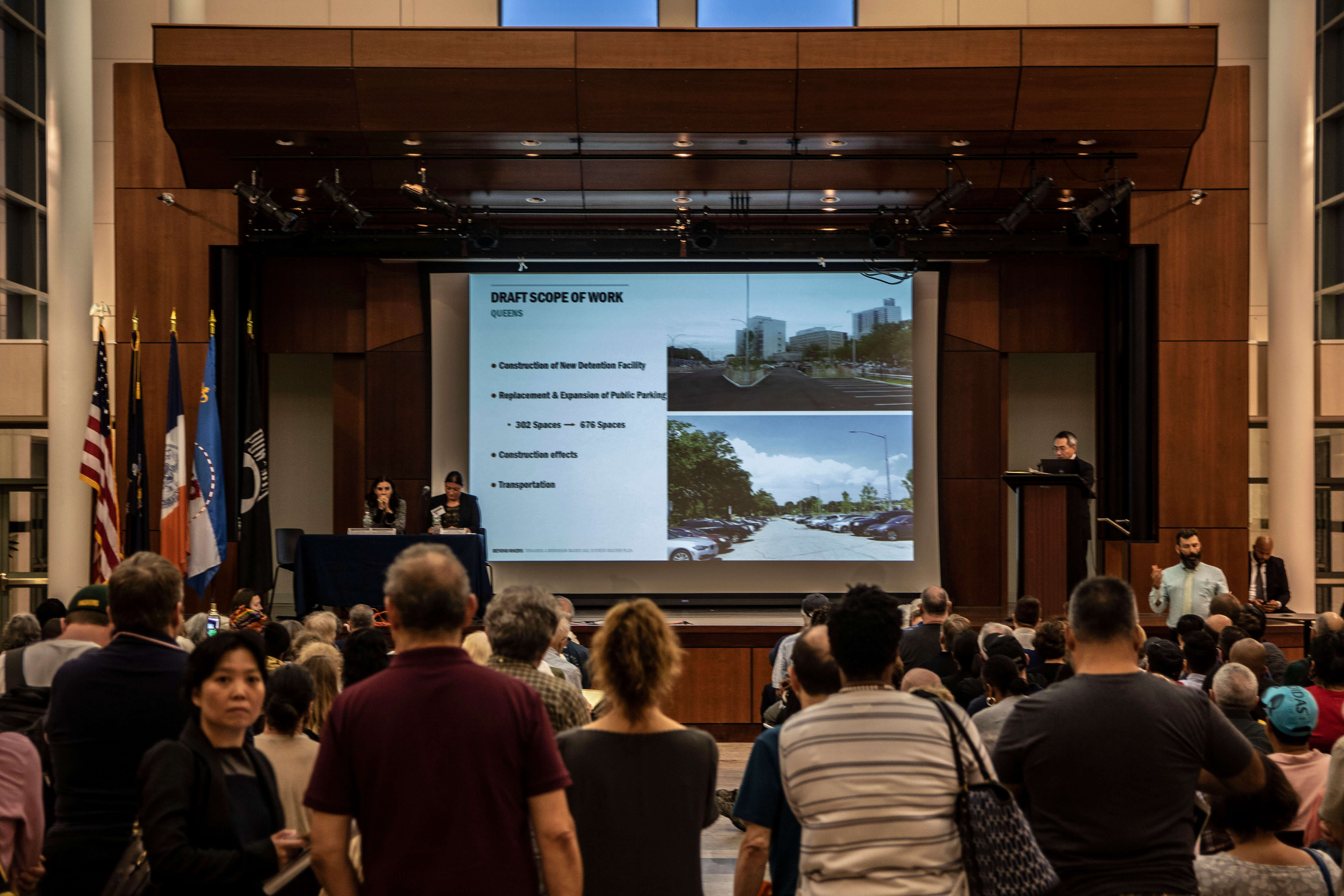Queens residents listen to a summary of the City's new proposed borough-based jail system at Borough Hall.