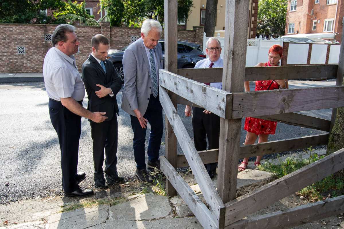 Senator Joseph Addabbo, Assemblyman Brian Barnwell, Councilman Robert Holden, Comptroller Scott Stringer and local resident Nancy Demino look at damage from a sewer project on 74th Street in Middle Village on Sept. 4.