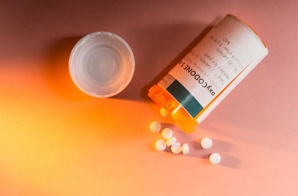 Oxycodone Prescription Bottle with Pills Spilling Out.