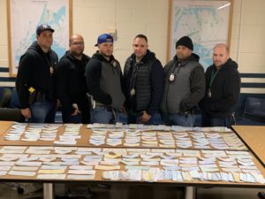 Checks taken from the fisher's vehicle. The officers include (from left to right) Sergeant Christopher Colon, Officer Elvin Lugo, Officer Caesar Romero, Officer Wilking Nunez, Officer Irving Mercedes and Officer Michael Carswell. All except for Mercedes and Carswell were involved in the arrest.