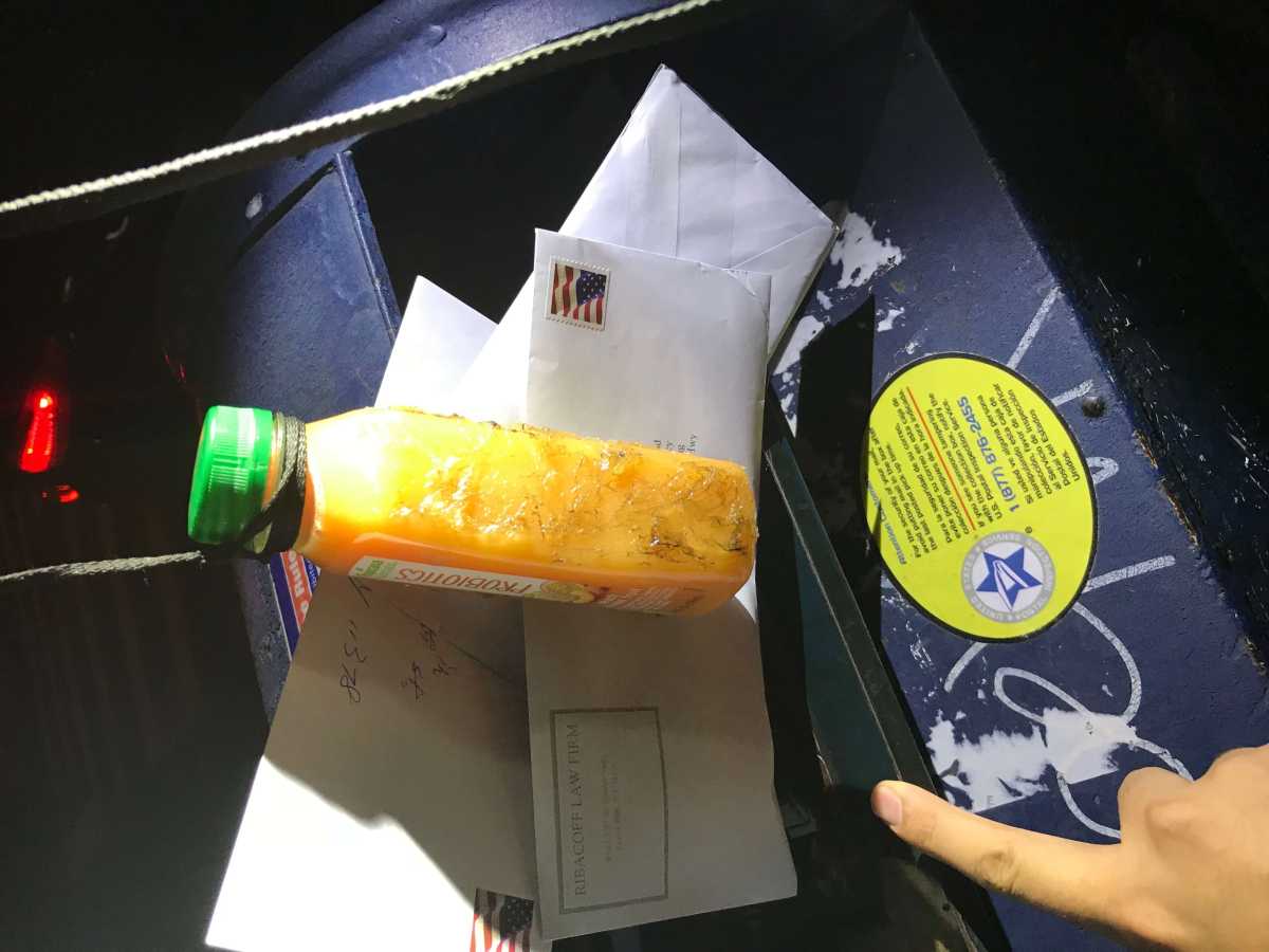 A juice bottle dipped in glue is an example of a fishing device used to steal checks from mailbox.