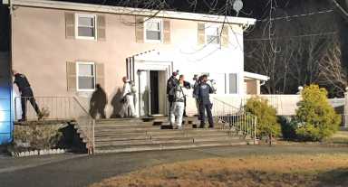Police officers outside the Mastic, Long Island, home that doubled as a drug lab allegedly operated in part by Elmhurst's Joseph Guida.