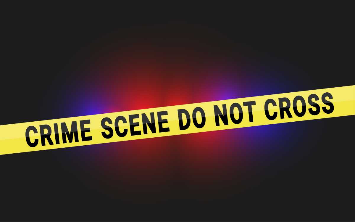 Crime Scene Do Not Cross Tape with Police Flashing Lights