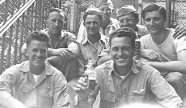 Upon their return to Ridgewood from various parts of the world, a game of softball or stickball brought “the gang” together for this
July 1945 photo at the Menahan Street entrance to the P.S. 81
school yard. Nino LoBello, who wrote for the Ridgewood Times, is pictured in the back row, second from right.