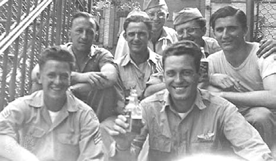 Upon their return to Ridgewood from various parts of the world, a game of softball or stickball brought “the gang” together for this
July 1945 photo at the Menahan Street entrance to the P.S. 81
school yard. Nino LoBello, who wrote for the Ridgewood Times, is pictured in the back row, second from right.