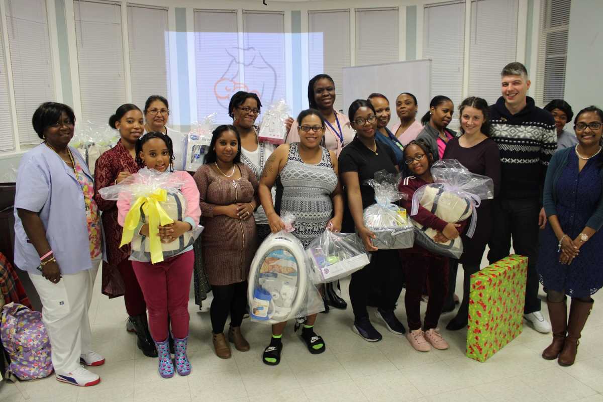 Denise Potts, MSN-ED, RNC, Director of Maternal Child Health (Back Row, Center) with SJEH staff and event attendees