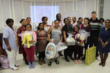 Denise Potts, MSN-ED, RNC, Director of Maternal Child Health (Back Row, Center) with SJEH staff and event attendees