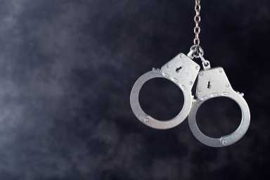 Handcuffs hanging on dark