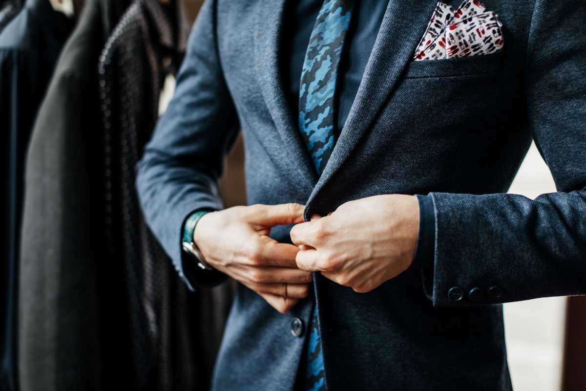 Close-Up Of Man Buttoning Up Suit