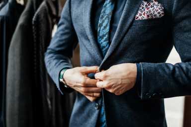 Close-Up Of Man Buttoning Up Suit