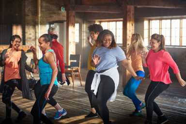 Women dancing in gym.