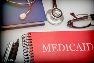 Titled red book medicaid along with medical equipment, conceptual image