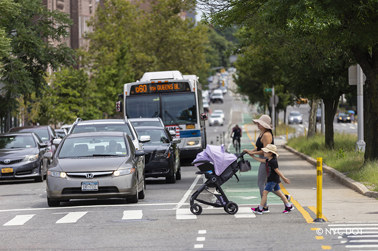 Pedestrian crossing the street at Queens Blvd, Queens.