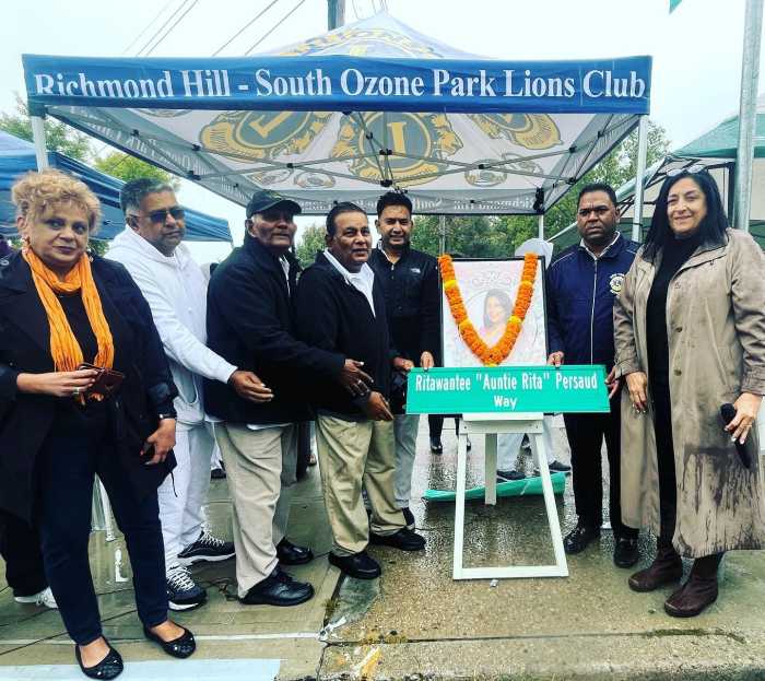 Ozone Park residents unveil a street sign honoring the late Rita Persaud.