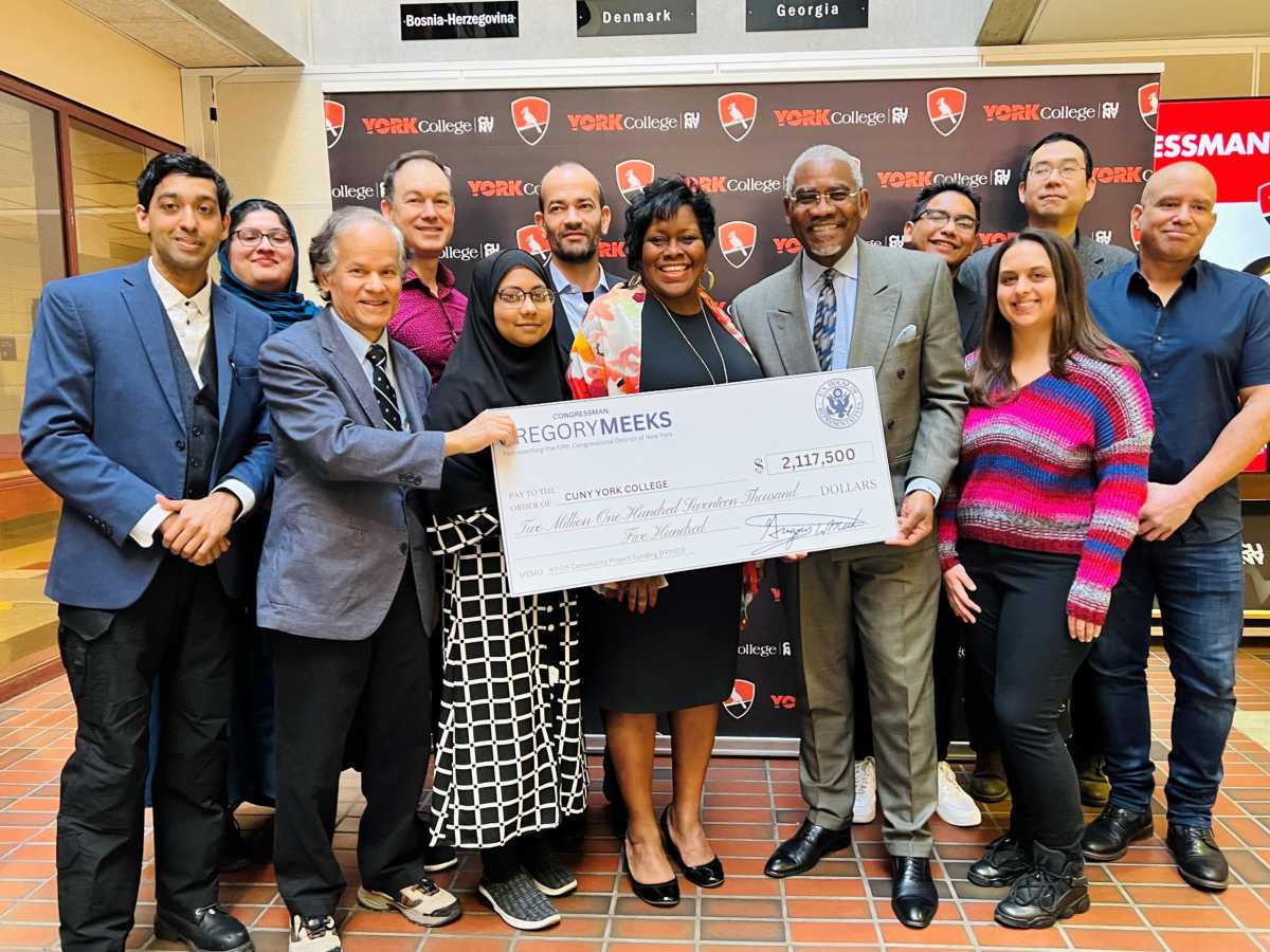 Meeks, faculty, students holding check