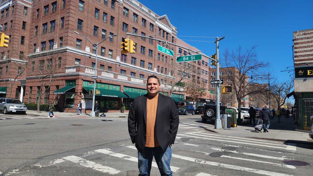 Sandro Navarro stands at the intersection of 84th Street and 37th Avenue at the border of Council District 21.