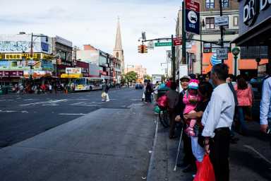 People waiting for the bus in Flushing Queens’ Chinatown