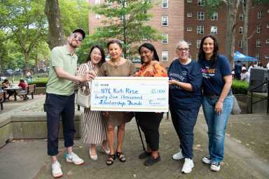 Rise Light & Power Director of External Affairs Wil Fisher, Council Member Julie Won, Congresswoman Nydia Velásquez, P.S. 151Q Parent Coordinator Naida Ryans, Woodside Houses Resident Association President Tammy Reyes, and NYC Kids RISE Founding Executive Director Debra-Ellen Glickstein celebrate the $25,000 Rise Light & Power Community Scholarship 2025 at Woodside Houses Family Day (July 19, 2025). Photo by Bridget Ye for NYC Kids RISE.