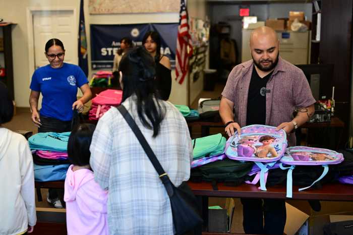 Raga distributes backpacks at Saturday's event. Photo: Ramy Mahmoud.